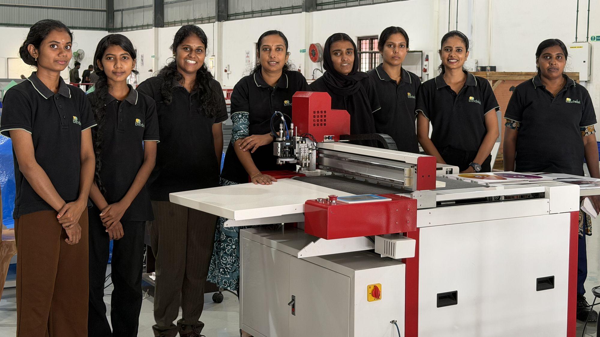 Eight women engineers and technicians of the Pappanamcode production team standing around a SigLoch XE-CUT